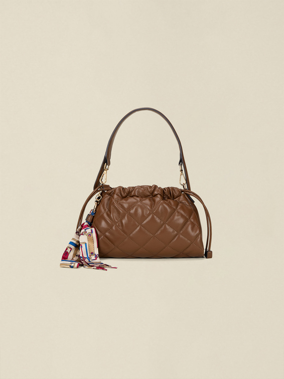 Quilted bag with drawstring and charm