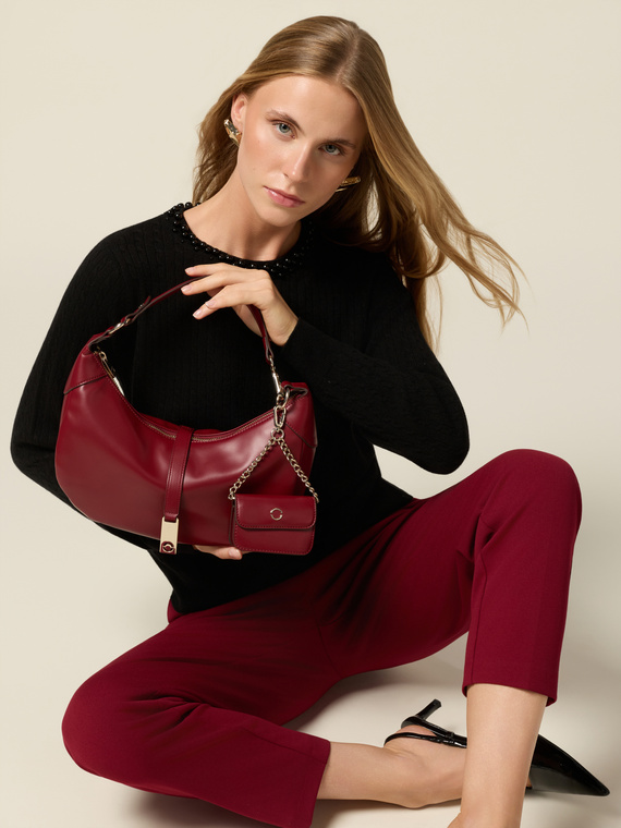 Shoulder bag with zip and metal charm