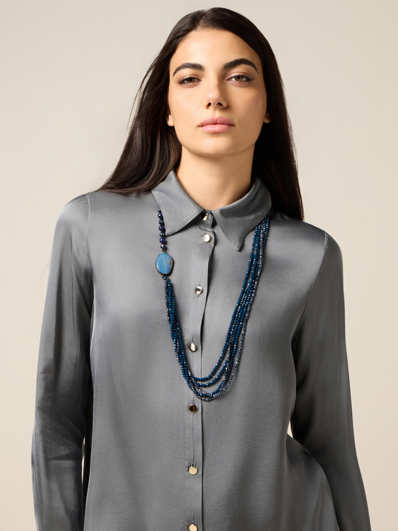 Multi-strand necklace with central element